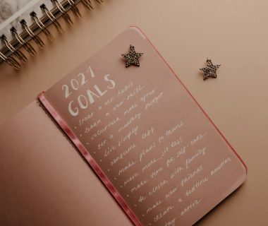 Top view of a 2021 goals notebook with handwritten list and star decorations, ideal for planning inspiration.